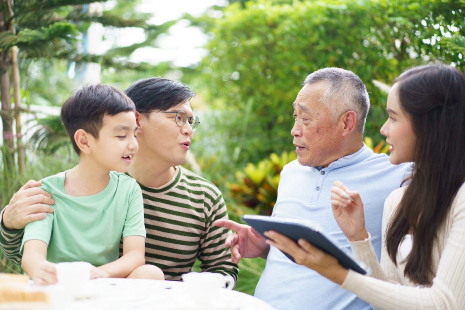 Family having a conversation in a garden.