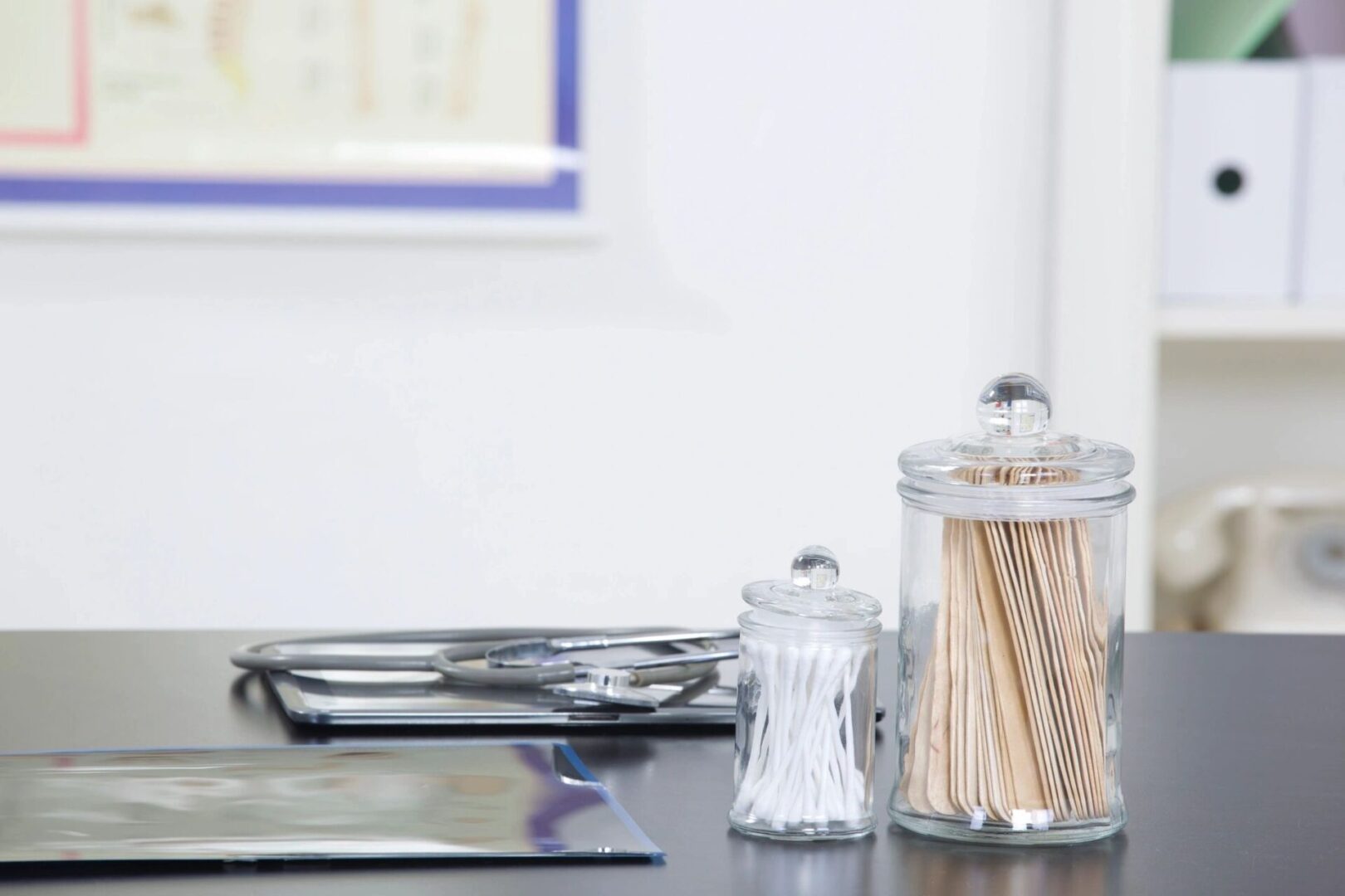 Glass containers holding toothpicks and salt on a kitchen counter.